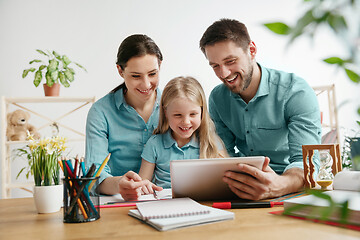 Image showing Young happy family are spending time together. A day with loved ones at home.