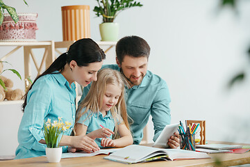 Image showing Young happy family are spending time together. A day with loved ones at home.