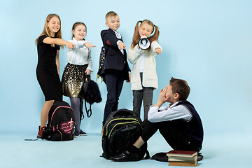 Image showing Little boy sitting alone on floor and suffering an act of bullying.