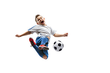 Image showing Young boy kicks the soccer ball