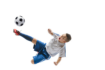 Image showing Young boy kicks the soccer ball