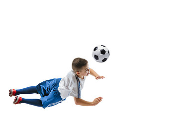 Image showing Young boy kicks the soccer ball