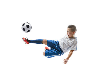 Image showing Young boy kicks the soccer ball