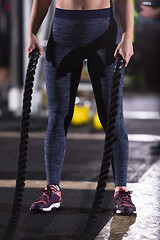 Image showing athlete woman doing battle ropes cross fitness exercise