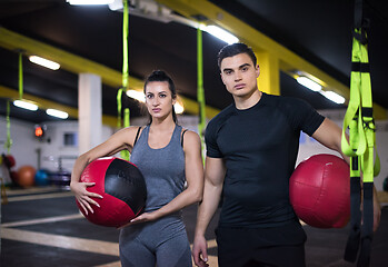 Image showing young athletes couple working out with medical ball