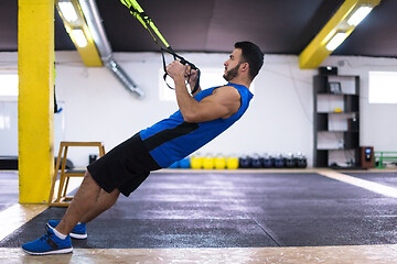 Image showing man working out pull ups with gymnastic rings