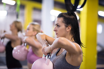 Image showing athletes doing exercises with kettlebells