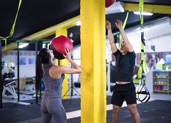 Image showing young athletes couple working out with medical ball