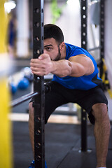 Image showing man doing pull ups on the vertical bar