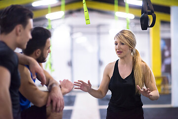 Image showing athletes working out  jumping on fit box