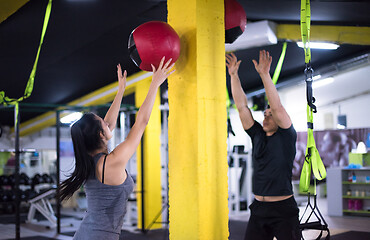 Image showing young athletes couple working out with medical ball