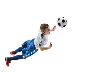 Image showing Young boy kicks the soccer ball