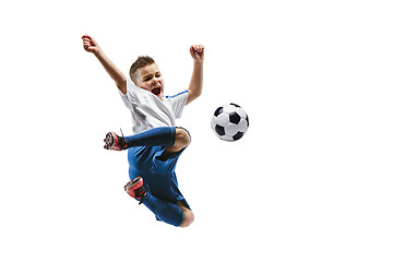 Image showing Young boy kicks the soccer ball