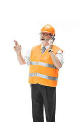 Image showing The builder in orange helmet isolated on white