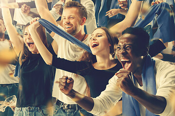 Image showing Group of happy fans are cheering for their team victory.