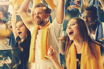 Image showing Group of happy fans are cheering for their team victory.