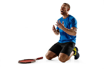 Image showing Portrait of a handsome male tennis player celebrating his success isolated on a white background