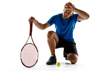 Image showing Tennis player crouching down looking defeated and sad