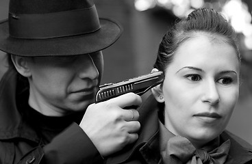 Image showing man threatens the woman with a pistol