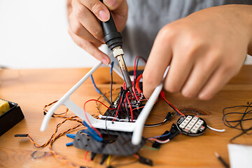 Image showing Welding the cable on drone at home