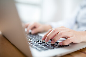 Image showing Woman hand typing on laptop keyboard