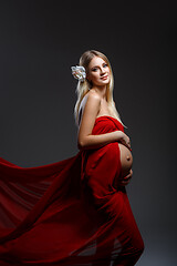 Image showing Pregnant girl in red dress