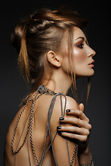 Image showing beautiful girl with many golden and bronze chains