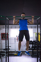 Image showing man doing pull ups on the horizontal bar