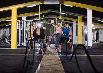 Image showing sports couple doing battle ropes cross fitness exercise