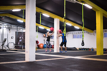 Image showing young athletes couple working out with medical ball