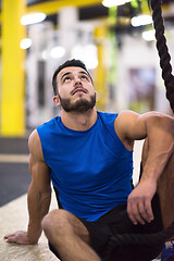 Image showing man relaxing before rope climbing