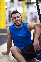 Image showing man relaxing before rope climbing