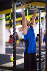 Image showing man doing pull ups on the horizontal bar