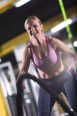 Image showing athlete woman doing battle ropes cross fitness exercise