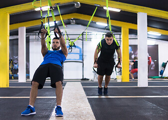 Image showing men working out pull ups with gymnastic rings
