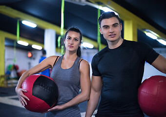 Image showing young athletes couple working out with medical ball