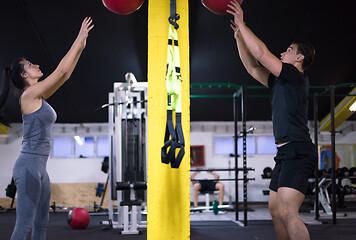 Image showing young athletes couple working out with medical ball