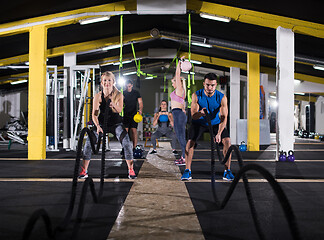 Image showing sports couple doing battle ropes cross fitness exercise