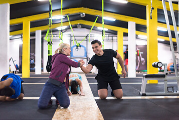 Image showing young healthy people doing pushups