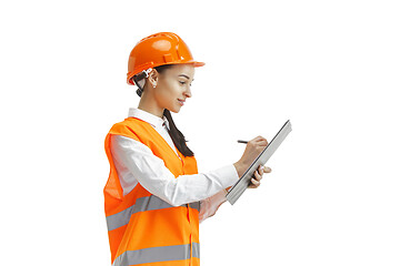 Image showing The female builder in orange helmet isolated on white