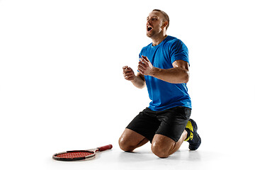 Image showing Portrait of a handsome male tennis player celebrating his success isolated on a white background