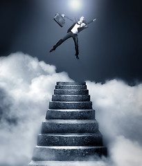 Image showing Businessman reaching heaven