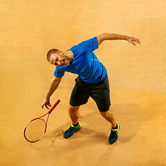 Image showing Tennis player crouching down looking defeated and sad