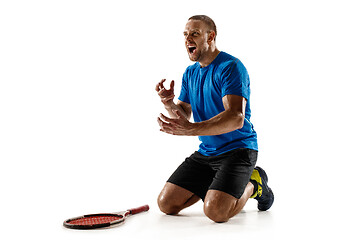 Image showing Portrait of a handsome male tennis player celebrating his success isolated on a white background