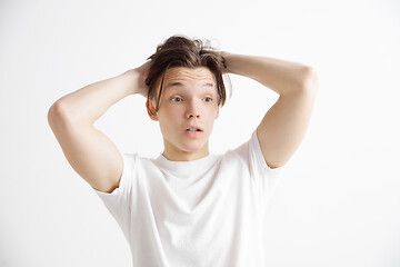 Image showing The young attractive man looking suprised isolated on gray