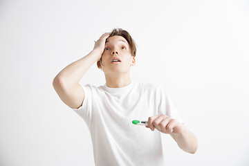 Image showing Upset man looking in pregnancy test. Frustrated model