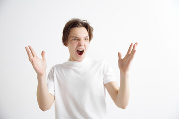 Image showing The young attractive man looking suprised isolated on gray