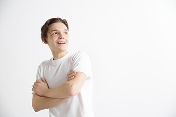 Image showing Young dreaming teenager isolated on white background looking at something