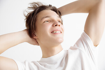 Image showing Young dreaming teenager isolated on white background looking at something