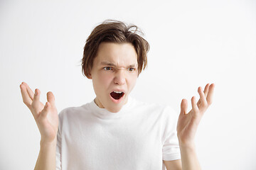 Image showing The young attractive man looking suprised isolated on gray